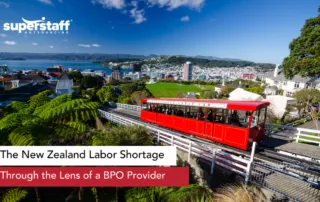 An image shows New Zealand city center. Caption says New Zealand labor shortage in the lens of a BPO provider.