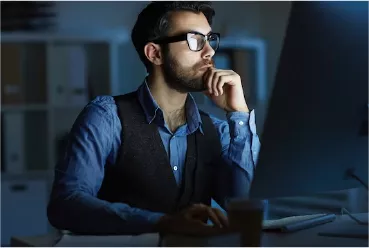 A Man Facing His Computer While Thinking