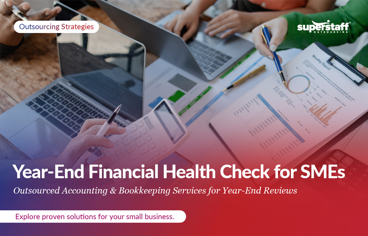 Accounting documents spread on the table. Image caption reads: Outsourced bookkeeping and accounting services for year-end financial health.