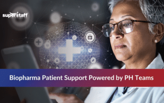 A medical professional reviewing data on a tablet, optimizing biopharma patient support services.