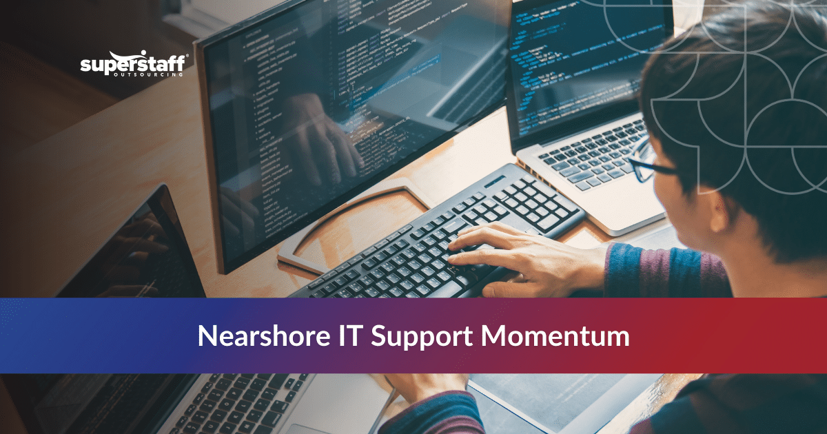 Specialist works at multi-monitor desk with code screens for help desk services outsourcing.